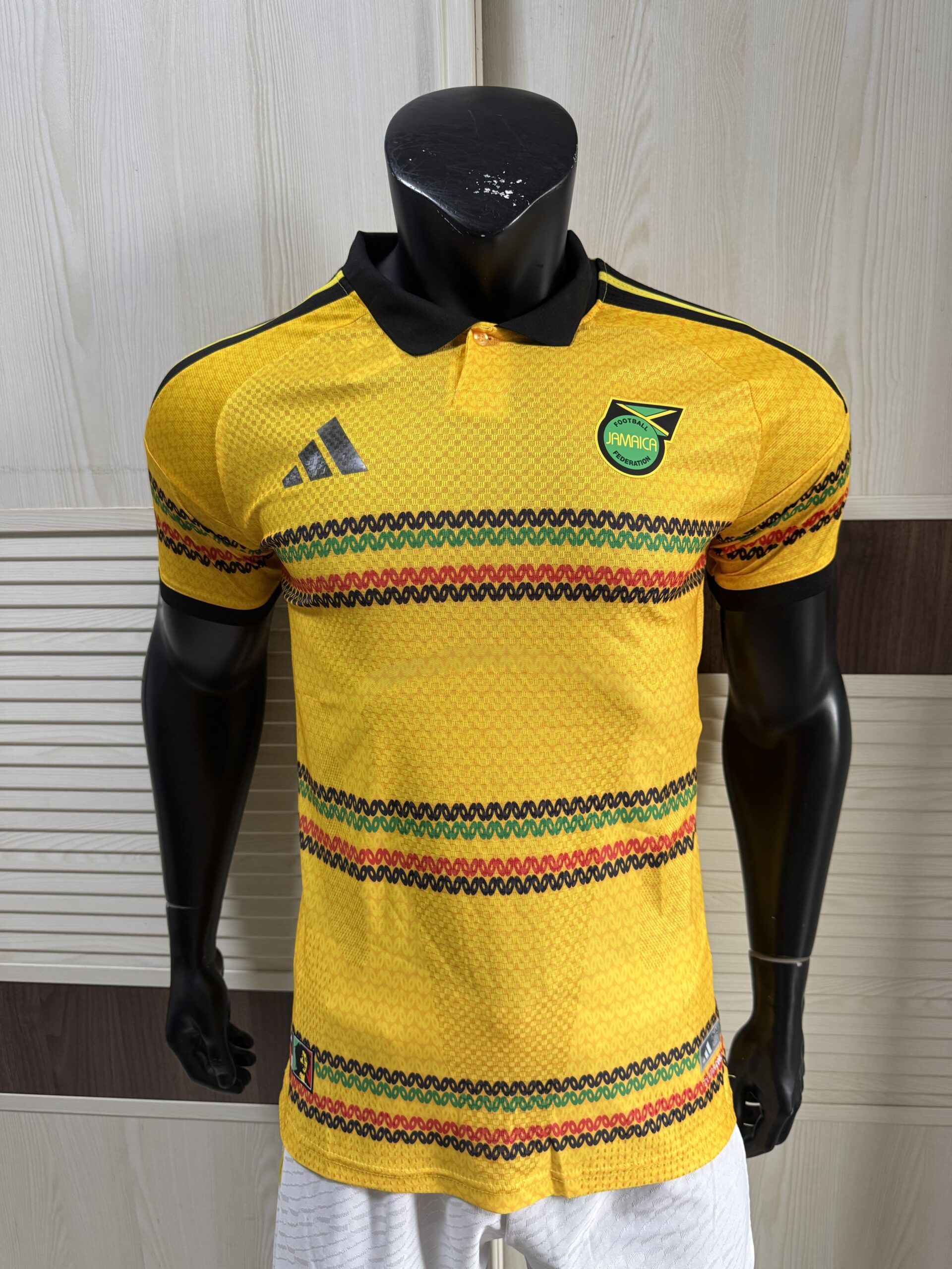 Adidas Jamaica 2026 x Bob Marley Home Authentic Jersey bold gold Reggae Boyz official kit front view showing iconic Bob Marley tribute design and authentic Jamaican football shirt